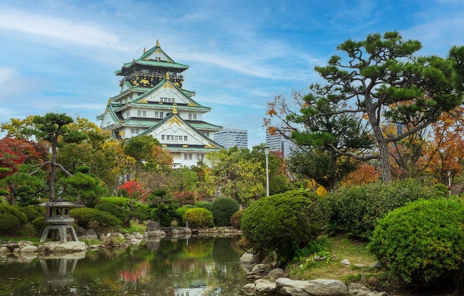 View of Osaka castle across the surrounding gardens.