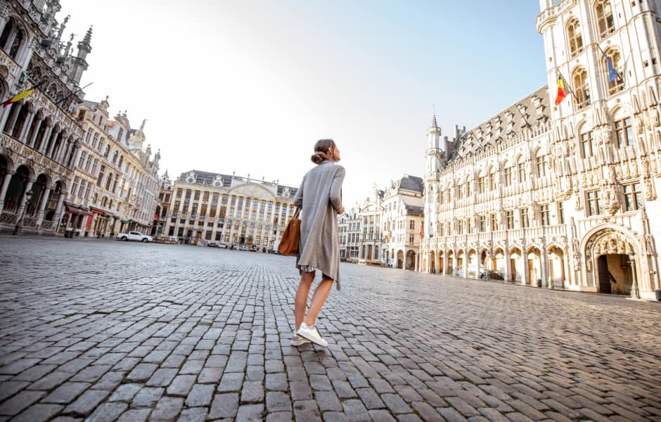 tourist walking on the main square with city hall in the old town of brussels in belgium