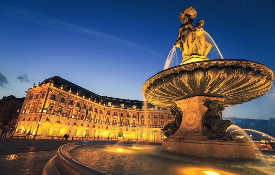 place de la bourse and fountain illuminated at night