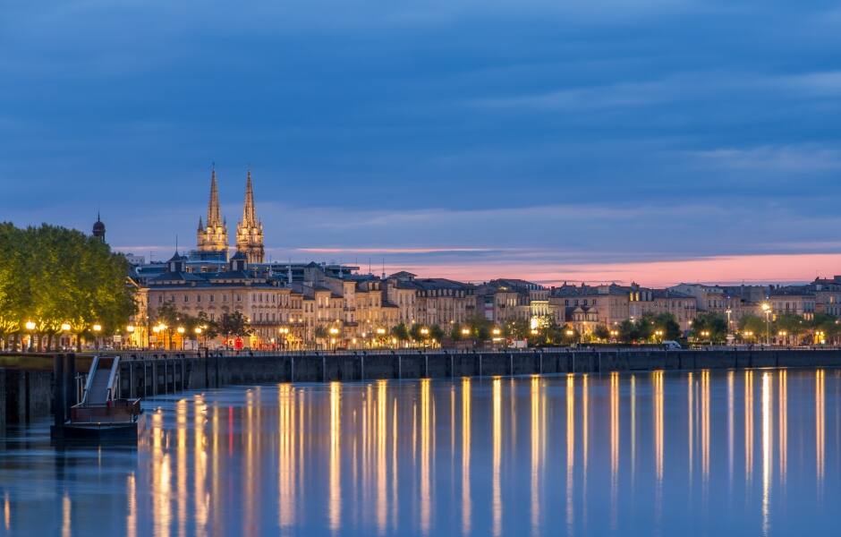 lights reflecting on the river garonne at night in bordeaux