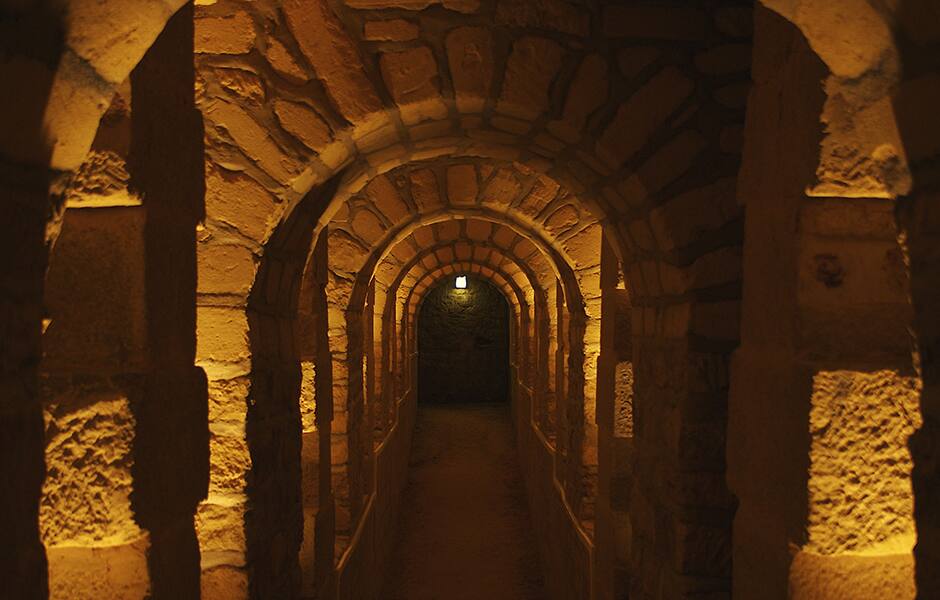 catacombs underground tunnels lit up in paris france