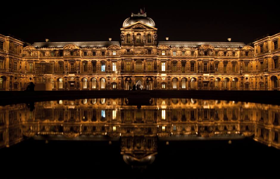 louvre courtyard and river in paris france at night 