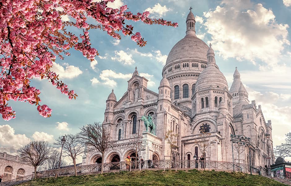 view of basilica sacre coeur in montmarte in paris with blossom tree