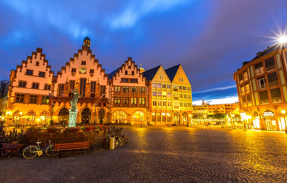 quaint romerberg old town square and statue at night