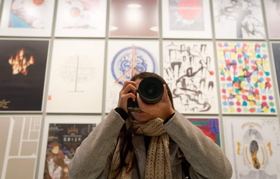 woman taking photo in hong kong museum