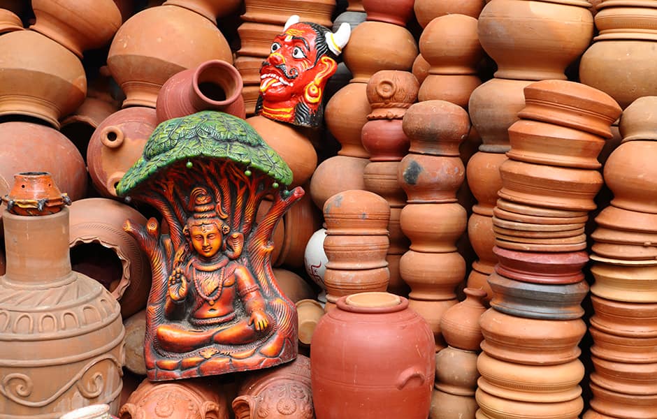 piles of ceramic pottery artcraft and a buddha statue