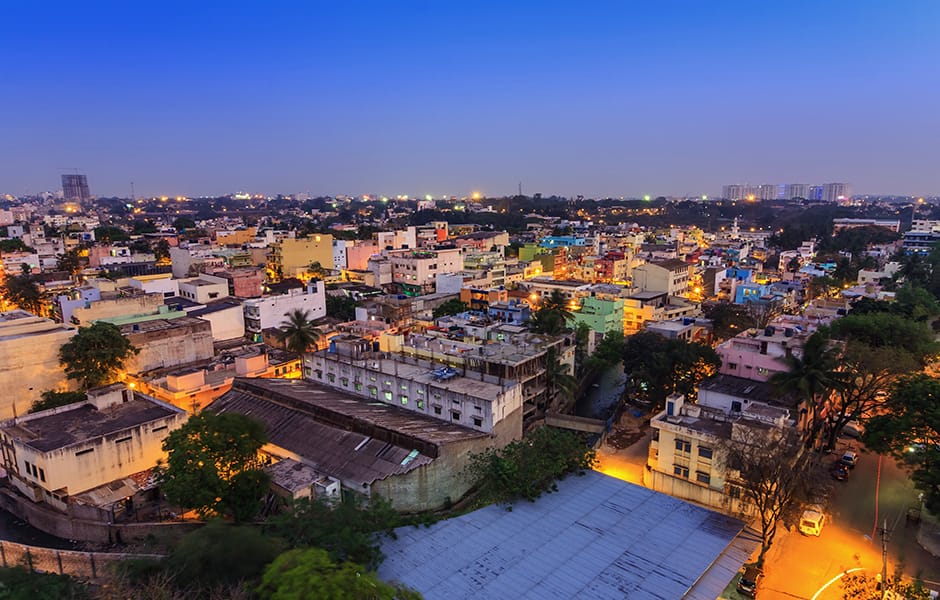 old buildings and crowd crossing the busy road of bengaluru