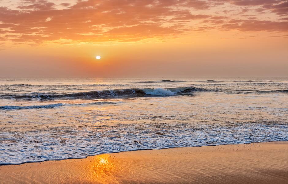 sunrise with beautiful orange sky on marina beach chennai