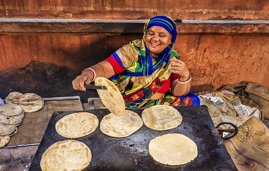 indian street vendor preparing food chapatti flat bread delhi