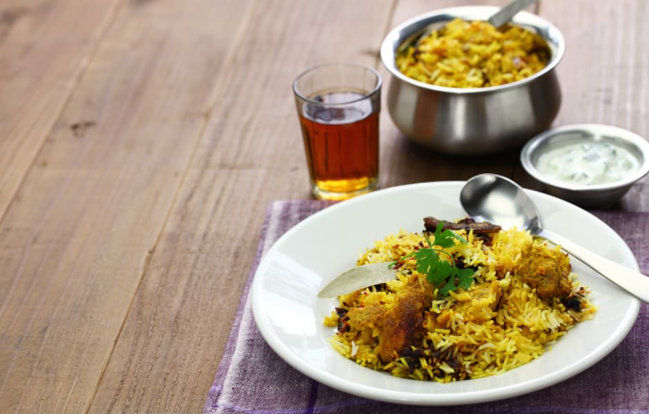 chicken biryani in a bowl on a plate india