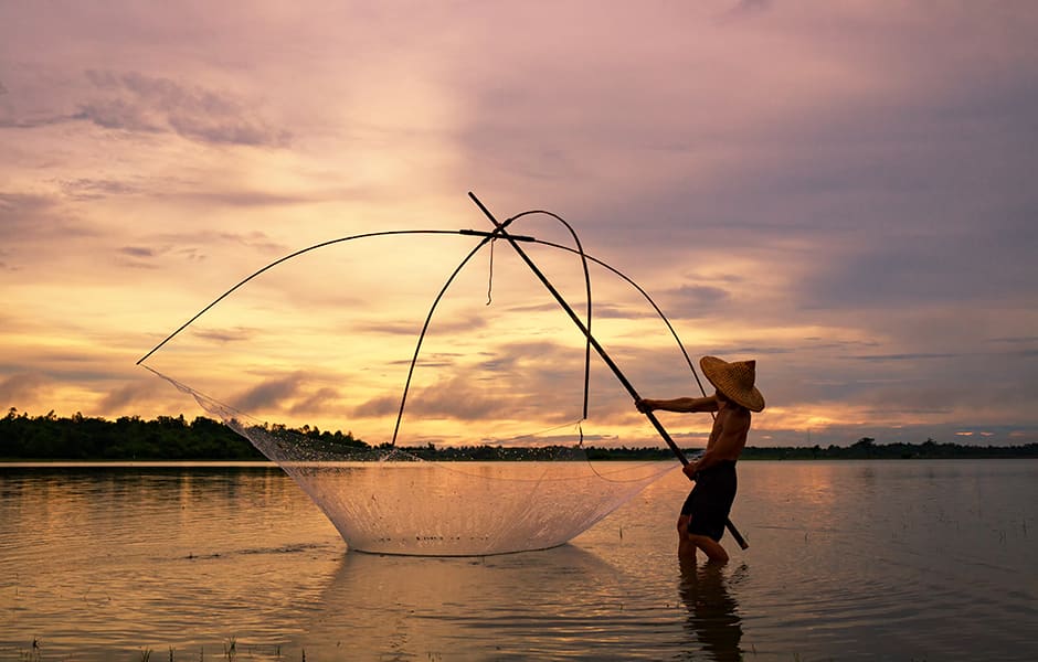 silhouette of a man fishing at sunset in kochi india