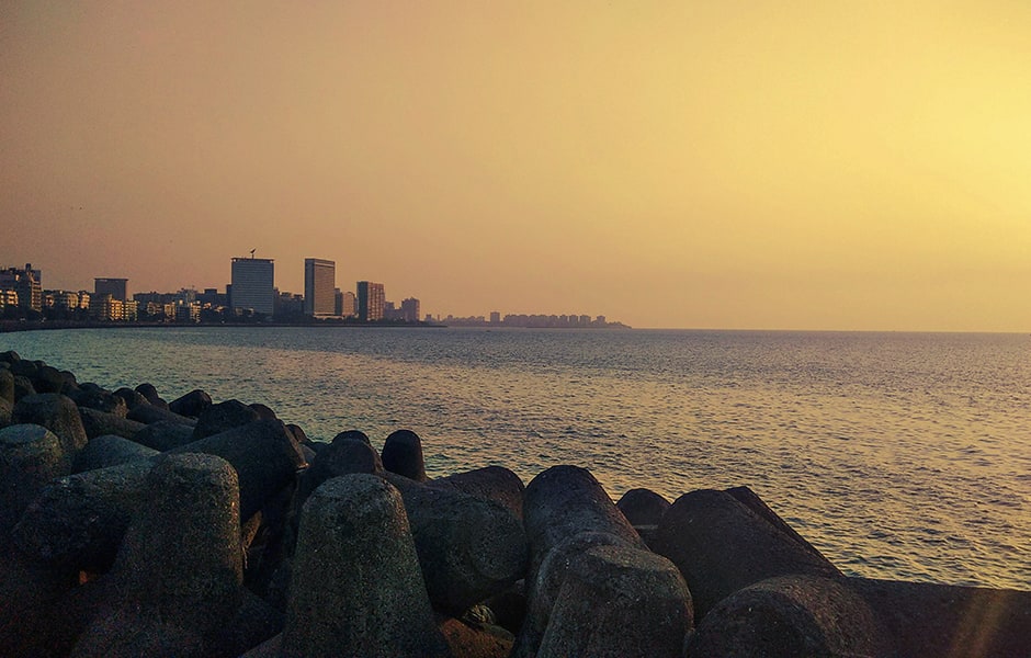 view of skyline at night from marine drive in mumbai india