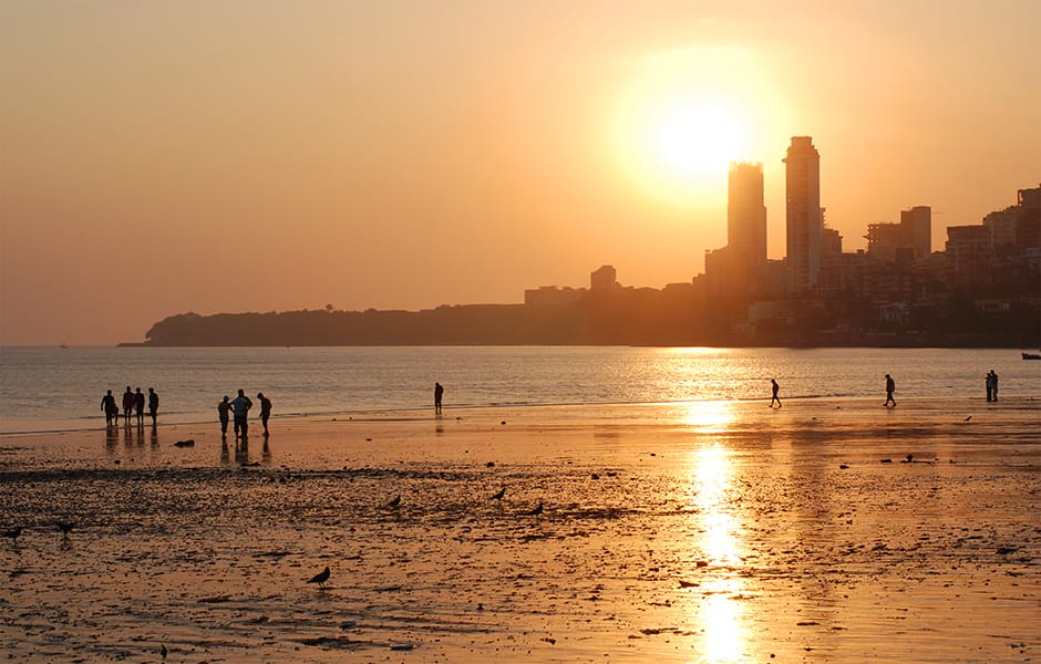 sunset over chowpatty beach in mumbai