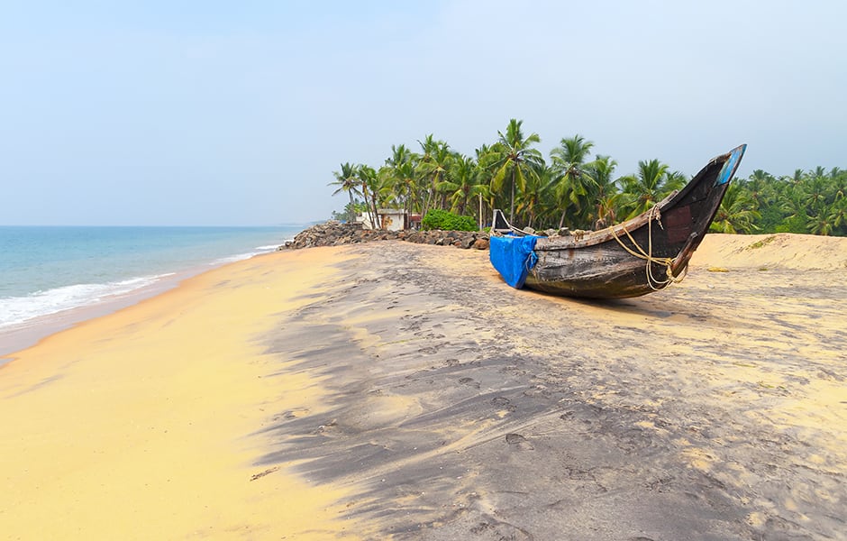 fishing boat on a tropical beach in thiruvananthapuram india