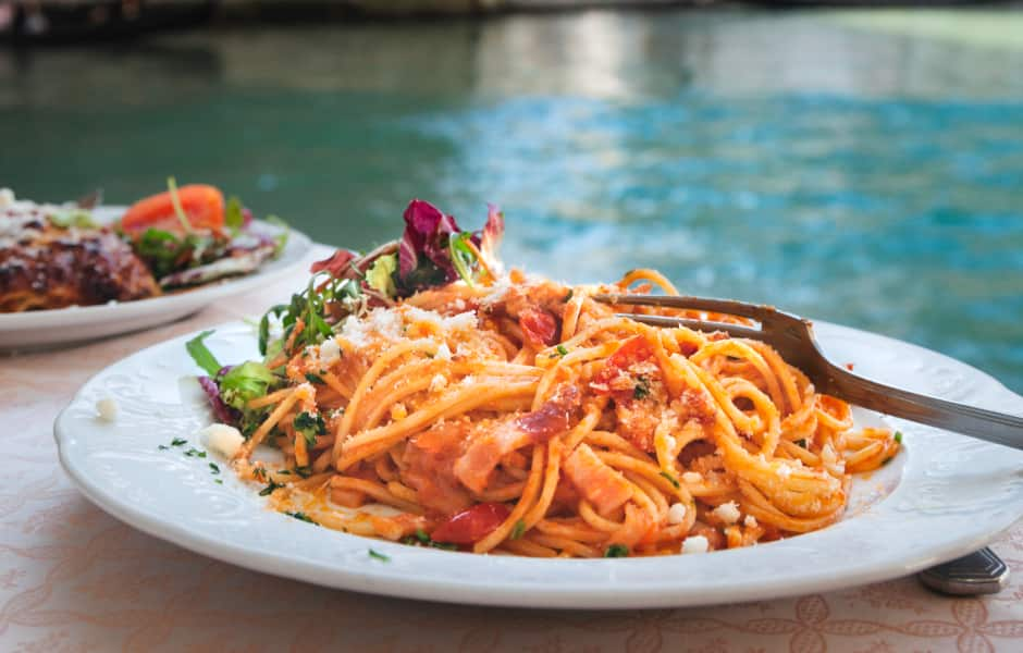 spaghetti dish in front of rialto bridge