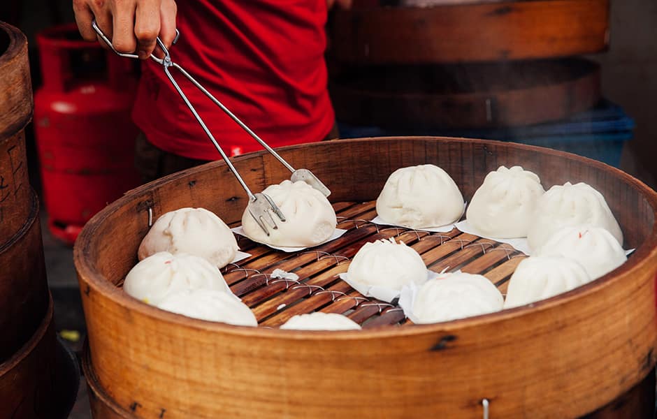 dumplings being cooked in a steamer