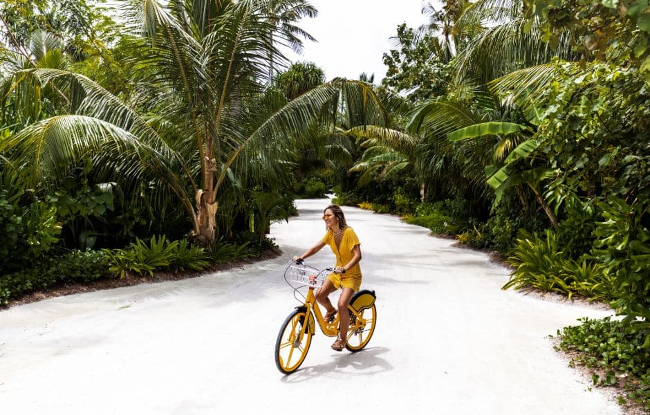 a young woman on a bike in a park in male maldives