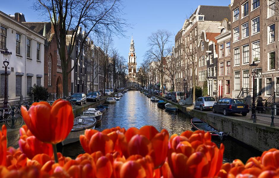 view of bicycles and canal on an autumn day in amsterdam