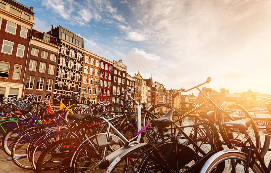 bikes on a bridge during a spring sunrise overlooking the river amstel