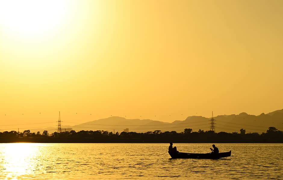 boating at rawal lake islamabad sunset hazy mountains in background pakistan