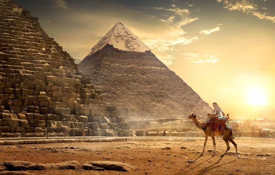 giza pyramids in the desert by sunset