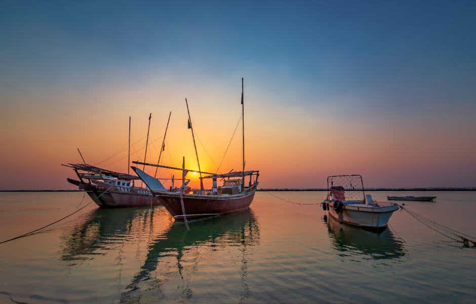 sunrise over sea and fishing boats in dammam saudi arabia