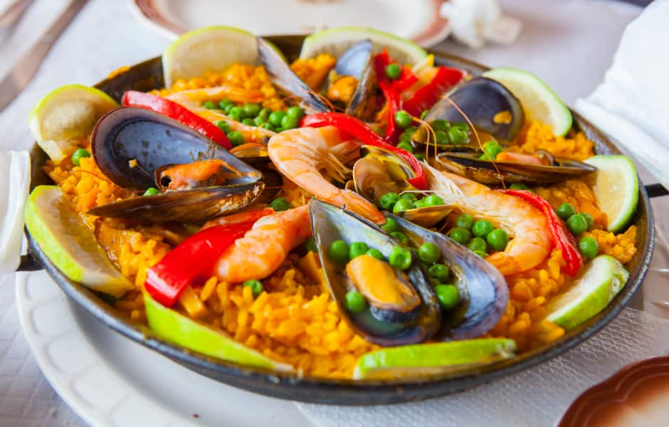 a bowl of spanish paella with shrimps and mussels