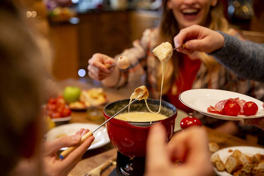 friends eating fondue in geneva switzerland