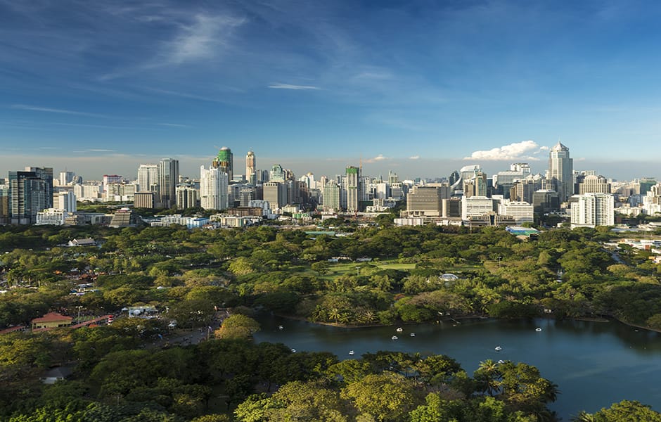 daytime view of lumphini park and the downtown bangkok city skyline thailand