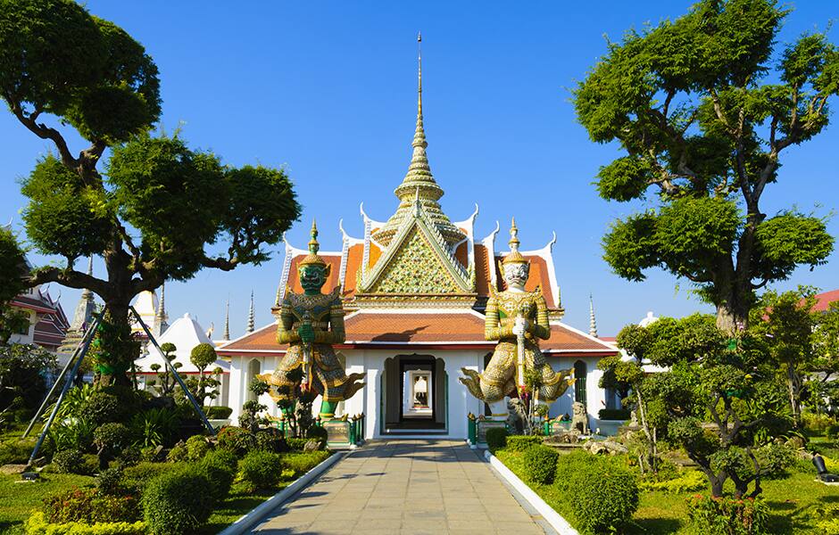 buddhist temple and ornate topiary trees in bangkok thailand 