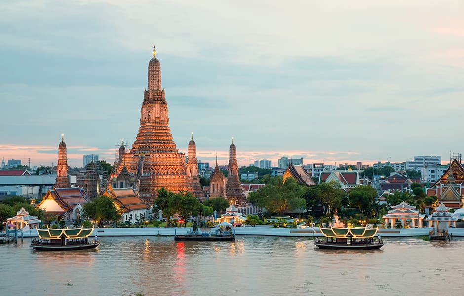 wat arun and cruise ship at night in bangkok thailand