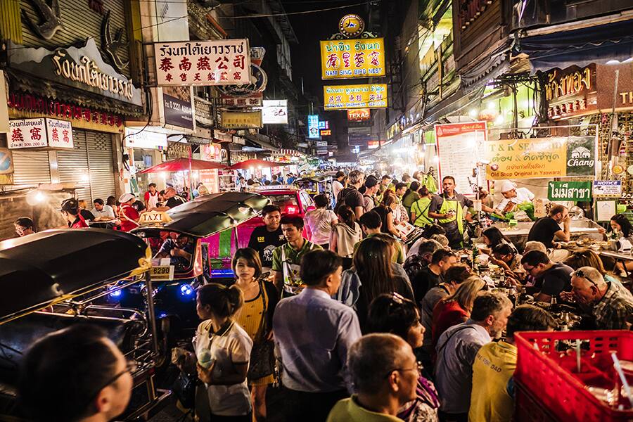 crowds enjoying street food at night in bangkok thailand