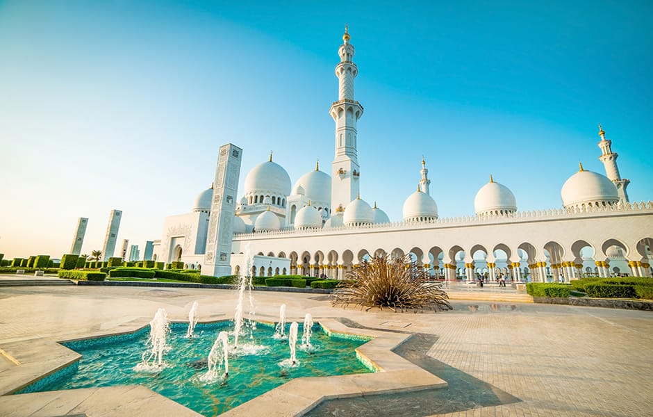 fountain and blue sky at the sheikh zayed grand mosque abu dhabi uae