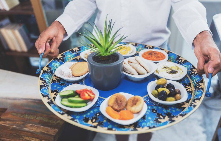 server holding middle eastern food platter