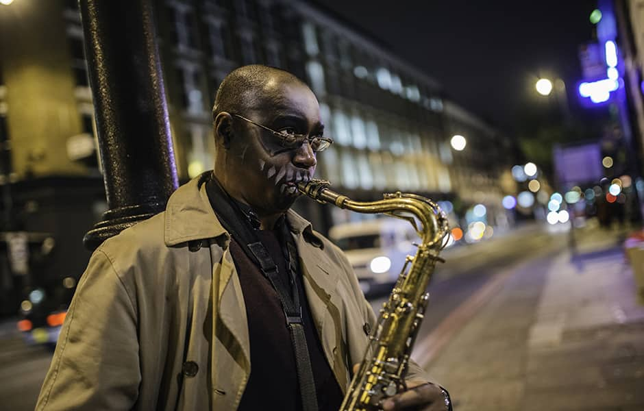 street performer playing the saxophone at night