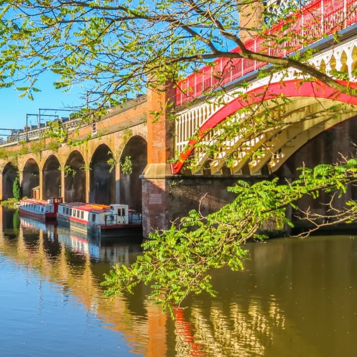 canal boats and bridge in castlefield manchester uk