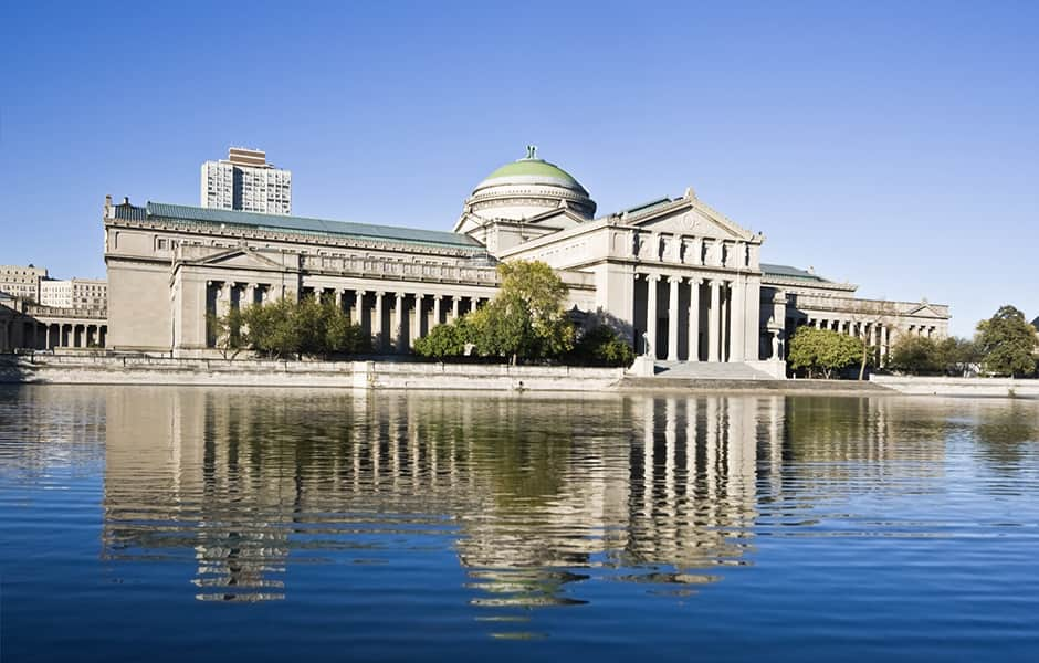 clear blue sky and museum of science and lake in chicago