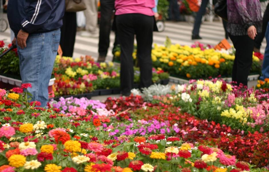 people shop for flowers in the eastern market detroit